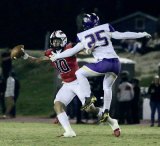 Lemoore's Daniel Rodrigues tries to block a pass from Hanford's Daniel Gomez in Friday night's West Yosemite Leauge finale.